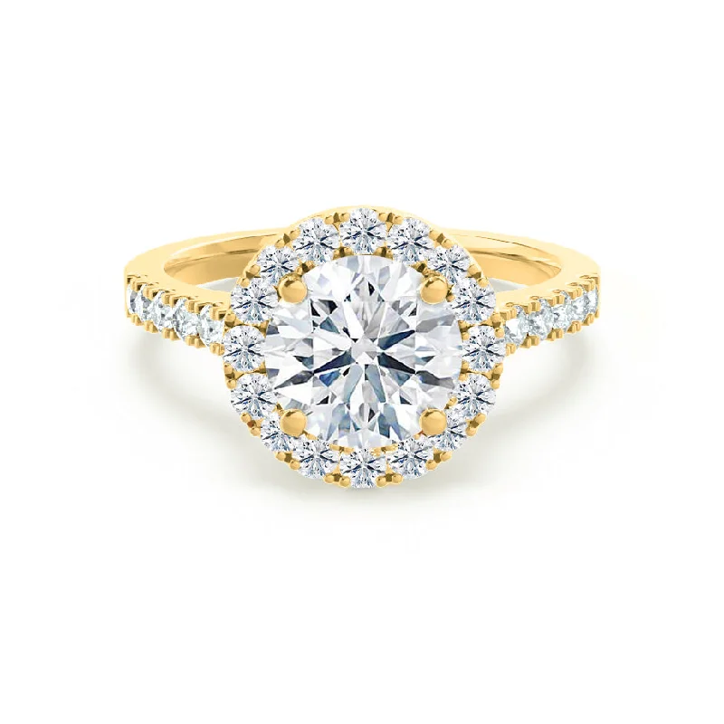 Solitaire diamond engagement ring with a platinum setting for a classic and elegant lookCECILY - Round Moissanite & Diamond 18k Yellow Gold Halo