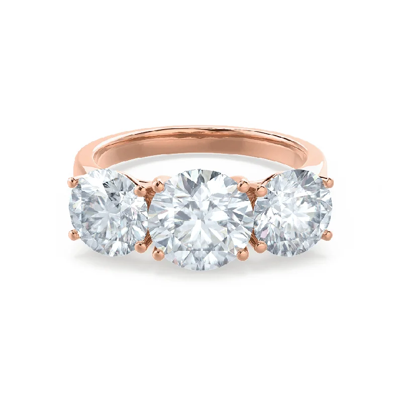 Three - stone diamond engagement ring in rose gold, symbolizing past, present, and futureLEANORA - Round Moissanite 18k Rose Gold Trilogy