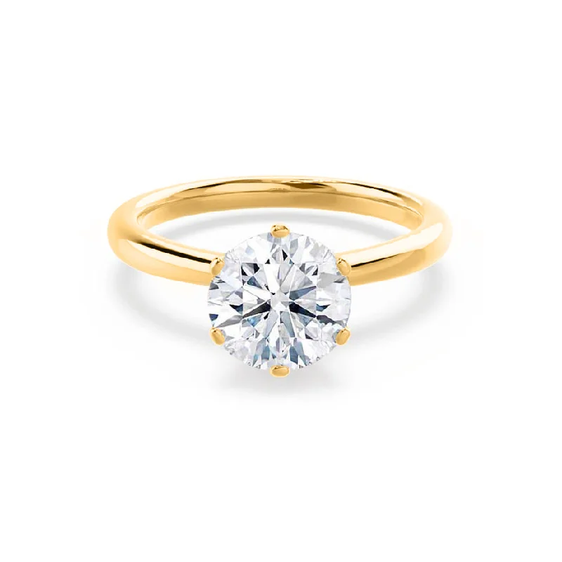 Solitaire diamond engagement ring with a platinum setting for a classic and elegant lookSERENITY - Round Moissanite 18k Yellow Gold Solitaire Ring