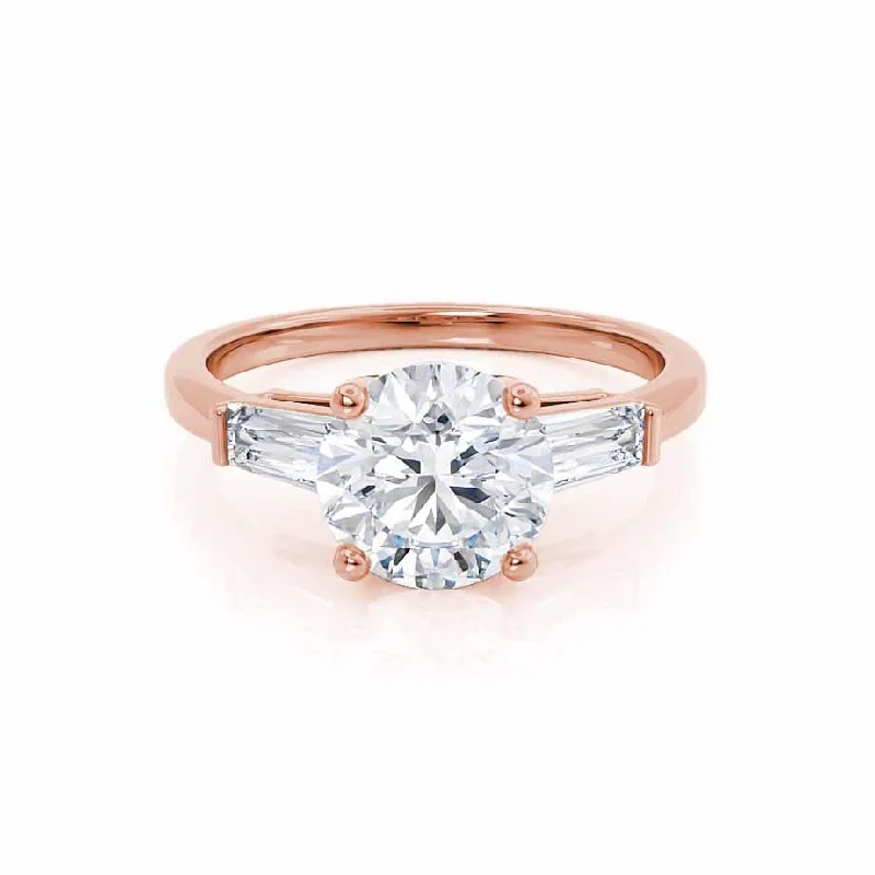 Halo diamond engagement ring in 18K white gold with a center oval - cut stoneLOVETTA - Round Moissanite & Diamond Baguette 18k Rose Gold Trilogy