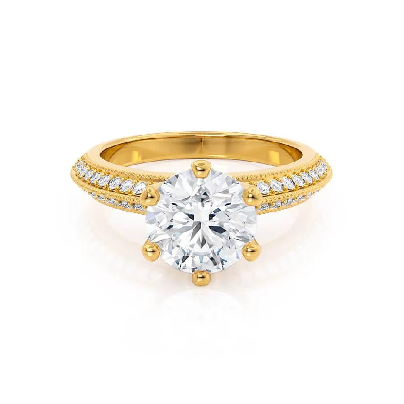 Pink diamond engagement ring in a rose - gold band with white - gold accentsVICTORIA - Round Moissanite & Diamond 18k Yellow Gold Shoulder Set Ring