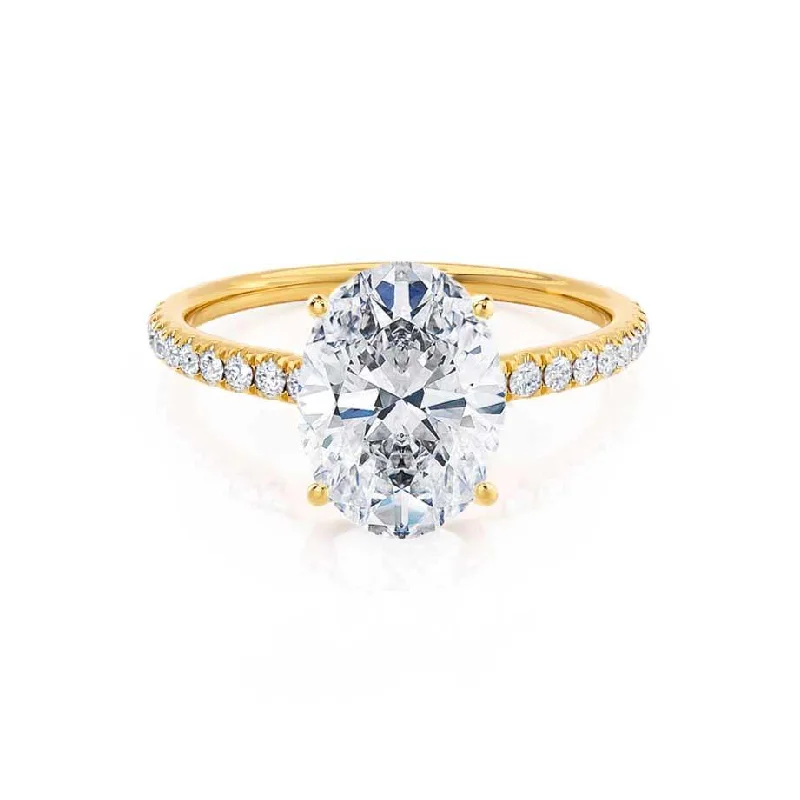 Three - stone diamond engagement ring in rose gold, symbolizing past, present, and futureMACY - Oval Moissanite & Diamond 18k Yellow Gold Petite Pavé Shoulder Set Ring