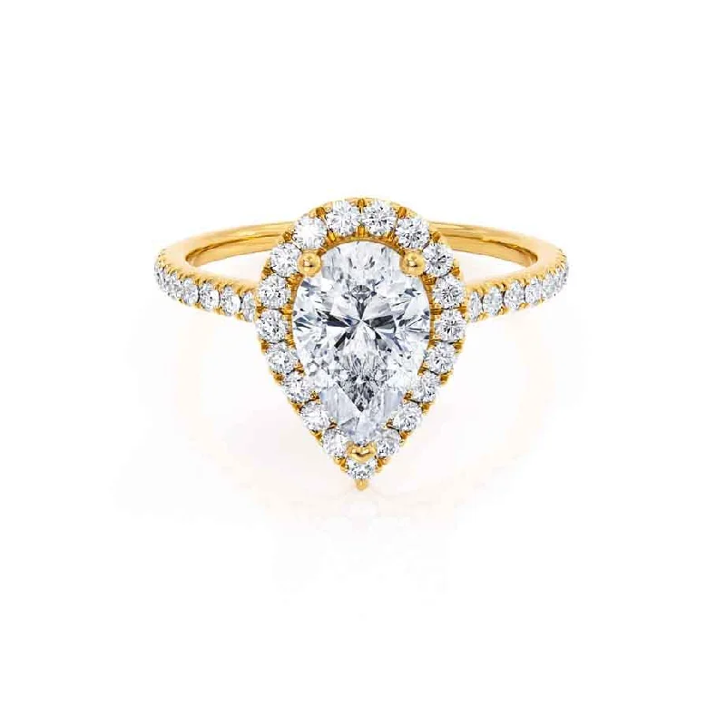 Radiant - cut diamond engagement ring with a bezel - set center stone in 18K yellow goldHARLOW - Pear Moissanite & Diamond 18k Yellow Gold Halo